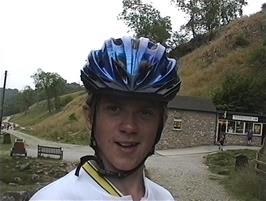 Gavin outside the entrance to Ingleborough Cave, where Fell Beck emerges from under the rocks